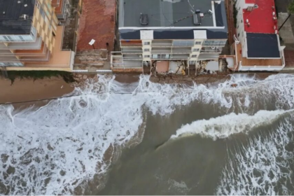 La indignació veïnal i la preocupació pel futur de la costa han tornat a prendre el passeig marítim de Tavernes de la Valldigna en una nova jornada de protestes. Centenars de residents s'han mobilitzat per a exigir a la Direcció General de Costes la regeneració urgent del seu litoral, greument afectat per la pèrdua d'arena i l'amenaça directa del mar sobre els habitatges. TAVERNES DE LA VALLDIGNA. 23 d'agost de 2026.— El malestar veïnal i la preocupació mediambiental han tornat a prendre els carrers de Tavernes de la Valldigna. Centenars de residents s'han mobilitzat aquest cap de setmana per a alçar la veu davant el que consideren una situació insostenible: la paulatina i imparable desaparició del seu front litoral a causa dels successius temporals marítims que afecten la zona. La pèrdua de superfície de platja ha aconseguit nivells sense precedents en el municipi. Segons els últims informes tècnics i mesuraments locals, algunes seccions de la costa han perdut fins a un 77% de la seua massa d'arena original, deixant el ferm de les zones habitades exposat a l'embat directe de l'onatge. Habitatges en perill i desallotjaments preventius La gravetat de l'erosió ha deixat de ser una mera pèrdua d'atractiu turístic per a convertir-se en un problema de seguretat pública. Els últims episodis de marejada i fort onatge van provocar l'esfondrament de murets de protecció i la infiltració d'aigua en les infraestructures costaneres, una situació que va obligar les autoritats locals a evacuar d'emergència diversos habitatges situats en primera línia de mar. Els propietaris afectats denuncien que la falta d'arena ha après el matalàs natural que abans amortia la força de les ones, deixant les fonamentacions directament exposades a la violència de la mar. Exigències a les administracions i silenci municipal La marxa pacífica va recórrer el passeig marítim exigint solucions definitives a la Direcció General de Costes i al Ministeri per a la Transició Ecològica. Els col·lectius veïnals reclamen superar la fase dels "parches d'emergència" —basats en l'aportació puntual d'arena que els temporals tornen a arrossegar— i executar projectes d'enginyeria de regeneració litoral duradors, com ara la instal·lació d'espigons o barreres submarines. Per la seua banda, el govern local ha evitat fer cap mena de publicitat de la convocatòria. Aquesta actitud manté la línia de l'alcaldessa, de signe socialista, qui igual que va evitar enfrontar-se amb el ministre Óscar Puente per a exigir la represa de les obres de l'estació d'ADIF, evita ara enfrontar-se amb els seus companys de partit a la Direcció General de Costes i a la Delegació del Govern. Els veïns, mentrestant, temen que l'arribada dels temporals de tardor i hivern cause danys estructurals irreparables a la localitat.